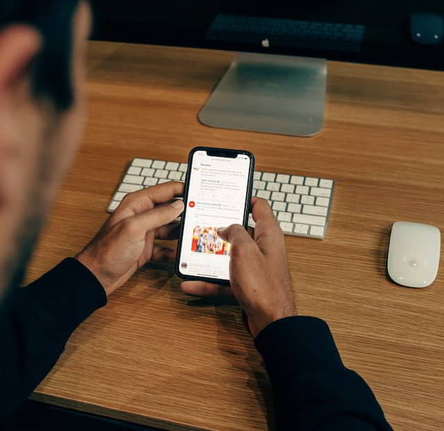 A man browsing his mobile looking for growth marketing services.